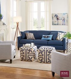 a living room filled with lots of furniture and decor on top of a hard wood floor