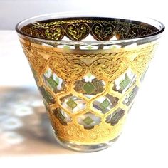 an ornate glass vase sitting on top of a table