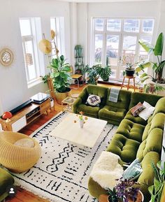 a living room filled with lots of green furniture