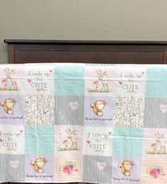 there is a baby quilt on top of the crib in front of a bed