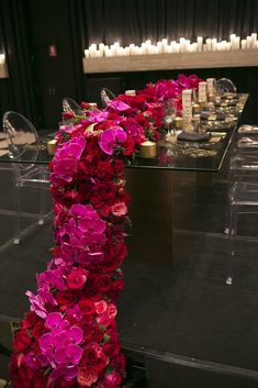 a long table with flowers and candles on it