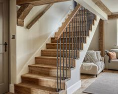 a living room filled with furniture and a stair case