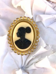 We are thrilled to have one of your handmade pieces featured in the Jason Statham movie The Beekeeper. Check us out in the last 20 mins. Small Gold Black and Ivory Cameo Brooch. The brooch is 1.5 inches (3 cm) long and 1.25 (2.5 cm) inches wide. This would look beautiful on a suit jacket or a coat.  From the Beloved collection celebrating African and African American heritage.  Sometimes a piece of art is more than simply beautiful. It evokes a culture, the struggle, beauty, strength, and the tr Jason Statham Movies, Jason Statham, Cameo Necklace, Cameo Brooch, American Heritage, Free Gift Cards, Bee Keeping, Simply Beautiful, Gold Black