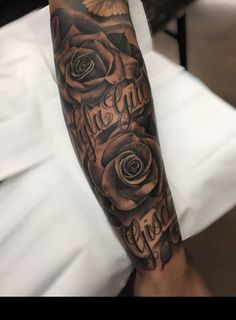 a black and grey rose tattoo with the words love on it's arm in cursive writing