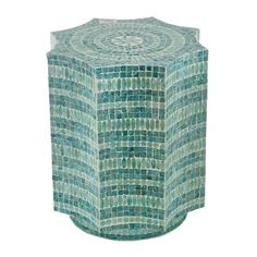 a blue and green mosaic tile table with circular design on the top, sitting in front of a white background