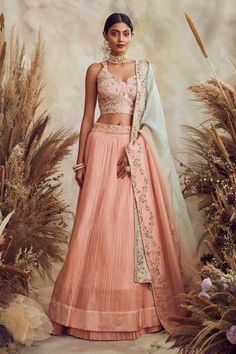 Peach lehenga with all-over pleats. Comes with embroidered blouse, dupatta and belt.
Components:4
Pattern:Embroidery
Type of Work:Cutdana, Sequin and Thread
Neckline:Sweetheart
Sleeve Length:Sleeveless
Fabric:Georgette and Organza
Color:Peach
Other Details:
Cutwork hem
Belt with bead hangings
Dupatta with embroidered border
Occasion:Wedding - Aza Fashions Pink Engagement Lehenga, Indian Wedding Dress Modern, Anarkali Bridal, Lehenga Ideas, Orang India, Peach Lehenga, Sari Lehenga, Engagement Lehenga, Shyamal And Bhumika