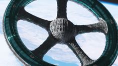 an artistic view of the inside of a vehicle wheel on top of snow covered ground