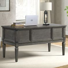 an office desk with a laptop on it