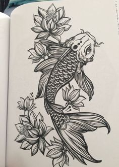 an open book with a drawing of a fish and flowers