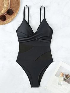 Indulge in the perfect blend of style and comfort with our Contemporary Elegance One Piece Swimsuit featuring a beautiful netting panel. This swimsuit is a modern take on classic beachwear, designed for the confident and fashion-forward individual. The contrasting mesh and twist details add a touch of sophistication, while the wireless bra and spaghetti strap neckline provide optimum support and a flattering silhouette. Crafted from a high-stretch knitted fabric, this swimsuit ensures freedom of Summer Swimwear With Built-in Bra And Mesh Material, Mesh Swimwear With Built-in Bra For Summer, Vacation Mesh Swimwear With Stretch, Mesh Stretch Swimwear For Vacation, Poolside Mesh Swimwear With Lined Body, Stretch Mesh Swimwear For Vacation, Mesh Swimwear For Beach Party Season, Party Mesh One-piece Swimwear, Black Mesh Swimwear For Vacation