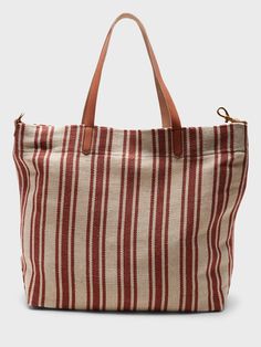 A sturdy canvas tote made to carry the essentials and then some.  Leather handles.  Hanging slip pocket inside.  Fully lined.  Height: 16" (41cm) Width: 13. 4" (34cm) Depth: 4. 75" (12cm)