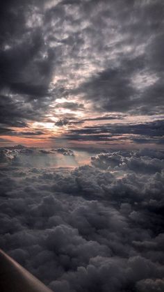 the view from an airplane looking down on clouds