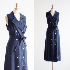 A chic, good quality dress, made from heavy navy blue Irish linen. It has a deeply notched collar, double breasted buttons, and a tie at the waist. Fully lined. ☛   m e a s u r e m e n t s   ☚ Best for: L Bust: 40 Waist: 35 Hips: 46 Length: 52 ☛   d e t a i l s   ☚ Era: 2000s Material: linen Brand: Talbot's Condition: excellent ☛   v i s i t   t h e   s h o p   ☚ https://etsy.me/2Nd23kg ☛ instagram ┇ poppycockvintage ☛ facebook ┇ poppycockvintage Summer Fitted Dress With Double-breasted Button, Fitted Summer Dress With Double-breasted Button, Formal Linen Dress With Button Closure, Double-breasted Fitted Summer Dress, Fitted Double-breasted Summer Dress, Summer Double-breasted Dress With Button Closure, Formal Linen Button Dresses, Formal Linen Dresses With Buttons, Double-breasted Summer Formal Dress