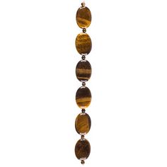 Take a walk on the creative side with Tiger Eye Oval Bead Strand. The strand features both oval and round spacer natural tiger eye beads. The beads' natural variations make them both visually appealing and reminiscent of nature itself. Create a stunning piece of jewelry using this lovely strand of beads!     Dimensions:   Strand Length: 7"  Bead Length: 4.5mm - 24mm  Bead Width: 4.5mm - 17mm      Card contains 1 strand. Brown Polished Oval Beads, Large Beads, Silhouette Cameo Machine, Fun Bracelet, Trendy Necklace, Print Coupons, Tiger Eye Beads, Bracelet Design, Semi Precious Beads