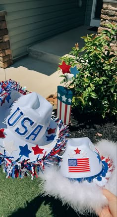 a patriotic hat with the number usa on it is sitting in front of a house