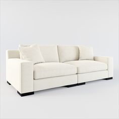 a white couch with two pillows on it