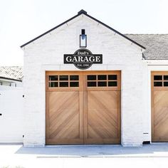 two garage doors are open in front of a white building