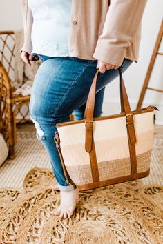 This WOVEN STRIPED TOTE BAG IN CORAL features a beautiful striped design of soft coral, off-white, and stone with touches of vegan leather. With a zippered back pocket, zippered opening. Has an adjustable and removable crossbody strap, and it is an ideal accessory for securely carrying your valuables. Plus, a cute addition to any outfit! Dimension 16” Long | 11” High | 5" Deep Shipping Free standard shipping on all orders of $150 or more! Free In-store Pick-up- This is a wonderful option if you Natural Color Braided Tote Beach Bag, Everyday Use Shoulder Bag With Striped Lining, Tote Bags With Striped Lining For Everyday Use, Casual Beige Bag With Striped Lining, Beige Diaper Bag Tote With Zipper Closure, Everyday Bags With Striped Lining, Everyday Tote Shoulder Bag With Striped Lining, Beige Tote Diaper Bag With Zipper Closure, Everyday Tote Bag With Striped Lining