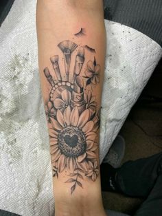 a woman's foot with a tattoo on it that has an image of a sunflower