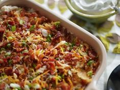 a casserole dish filled with lots of toppings on top of a table