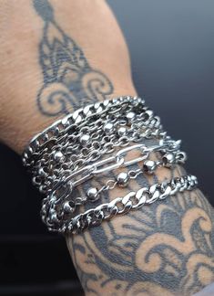 Layered Multi-Strand Steel Bracelet - This punk style or alt goth statement bracelet makes a great gift for her. All stainless steel so this bracelet will NOT tarnish. Completely water proof.  Chains may differ slightly based on stock, but will be same quality, size, and style. ⚡Sizing to help you choose the most accurate size of bracelet. ⚡ Step 1:   Measure your wrist (where you often wear your bracelets) with a tape measure or a long strip of paper, and get your wrist circumference. Step 2:   For a  snug fit, add a 1/2 inch. For a comfort fit, add 1 inch. ⭐RECOMMENDED SIZES:⭐ 7 inch: Extra small frame biological female 7.5 inch: Small frame biological female 8 inch: Medium frame biological female, small frame biological male 8.5 inch: Large frame biological female, medium frame biologic Punk Style Bracelets With Studs, Metalhead Bracelets, Black Punk Chain Bracelet As A Gift, Black Punk Style Chain Bracelet As Gift, Black Punk Style Chain Bracelet For Gift, Punk Style Black Chain Bracelet Gift, Trendy Silver Chain Bracelet For Streetwear, Adjustable Stainless Steel Punk Bracelets, Trendy Silver Bracelets For Streetwear