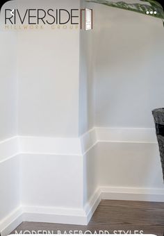 the corner of a room with white walls and wood flooring is shown in this image