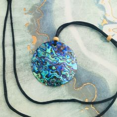 This beautiful necklace feature a large-2 inch round Abalone shell (New Zealand Paua shell ) Pendant .The iridescence of these Paua Abalone is truly amazing .Depending on the angle of the light source they will radiate colors from greens and pinks to purples and blues. The shells are then polished to a high gloss to reveal the beauty of their natural pattern. The pendant is held by an attractive black satin cord that is adjustable for your perfect fit. DETAILS - Shell Types : Paua Abalone Shell Adjustable Iridescent Round Necklaces, Bohemian Round Shell Necklace For Gift, Bohemian Round Shell Necklace Gift, Bohemian Round Shell Necklace As Gift, Handmade Round Abalone Shell Necklaces, Adjustable Round Bohemian Shell Necklace, Adjustable Round Shell Necklace For Beach, Adjustable Round Shell Necklace For The Beach, Adjustable Round Pendant Necklace For Beach