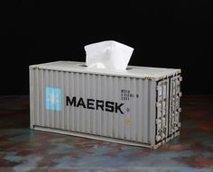 a gray container with a tissue paper on top of it that says maersk