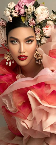 a mannequin with flowers on it's head wearing a pink dress and earrings