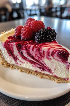 a slice of cheesecake with raspberries on top