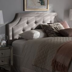 a bedroom with a bed, nightstands and two lamps