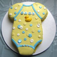 a cake shaped like a bodysuit with a rubber ducky on it