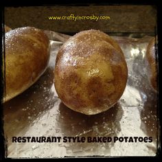 three baked potatoes sitting on top of aluminum foil