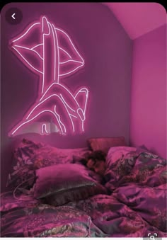 a bed in a room with a neon sign on the wall above it that says neon