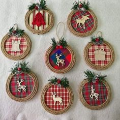 six christmas ornaments hanging from twine on a white sheet with red and green plaid