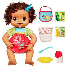 a baby doll with lots of toys in it's hands and some food on the ground