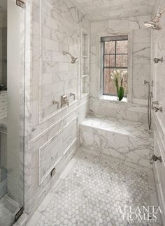 a bathroom with marble walls and floors