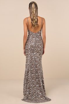 the back of a woman wearing a silver dress with an animal print pattern on it