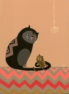 a cat and a kitten sitting on top of a chevron blanket with a bird in the background