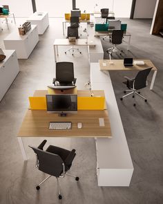 an office with multiple desks and chairs on each side, all in different colors