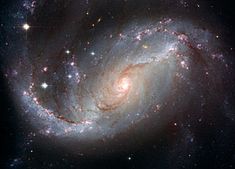 an image of a spiral galaxy with stars in the night sky, taken from space