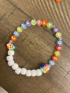 a beaded bracelet with the word hello written on it and beads attached to it