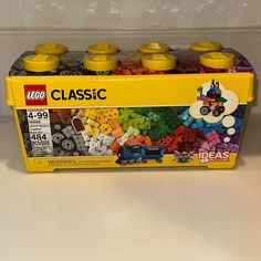 a yellow lego box filled with lots of colorful legos