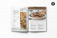 a recipe book with waffles and blueberries on it is open to the page