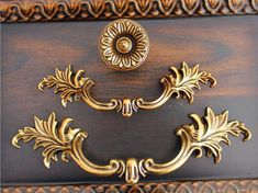 an ornate wooden cabinet with brass handles