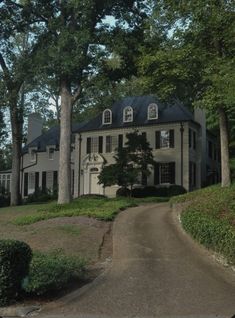 a large white house sitting on the side of a road