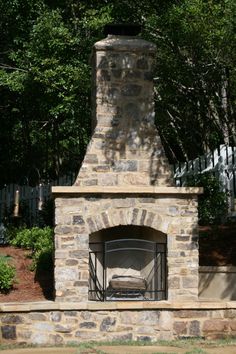 an outdoor fireplace with a bed in it