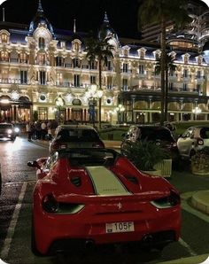 a red sports car parked in front of a hotel