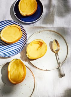 three plates with desserts on them sitting on a table