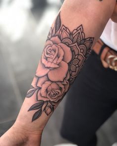 a person with a rose tattoo on their arm